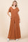 woman wearing a rust-colored wide-leg jumpsuit with short sleeves and pockets