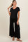 woman wearing a black ribbed maternity jumpsuit with short sleeves and wide legs, showcasing her baby bump
