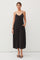 woman wearing a black sleeveless maxi dress with pockets and a flowy silhouette
