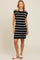 woman wearing a black and white striped knitted dress with short sleeves and a fitted silhouette