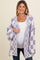 woman wearing a purple and white checkered maternity cardigan over a white top, showing a baby bump