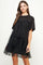 woman wearing a black t-shirt dress with layered tulle ruffles and short sleeves