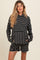 woman wearing a black and white striped maternity lounge set with a hoodie and shorts