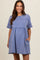 woman wearing a blue maternity dress with short sleeves and gathered waist, featuring frayed edges and pockets