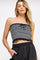 woman wearing a black and white striped strapless crop top with ruffle hem and front tie detail