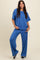 woman wearing a blue cozy two-piece set featuring a short-sleeve top and wide-leg pants