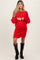 woman wearing a red knitted maternity dress with a relaxed fit and long sleeves, showing a visible baby bump