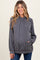woman wearing a gray ribbed maternity hoodie with a front pocket and drawstring hood, smiling at the camera