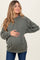 woman wearing a green ribbed maternity hoodie and holding her baby bump