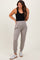 woman wearing a black tank top and grey maternity joggers with pockets, showing off her baby bump