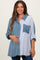 woman wearing a maternity oversized button-up shirt with denim and striped patterns, holding her baby bump