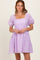 woman wearing a lilac short puff sleeve dress with a square neckline and checkered pattern