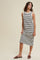 woman wearing a black and white striped sleeveless midi dress with a relaxed fit