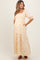 woman wearing a floral printed yellow maternity maxi dress with puff sleeves and pockets, showcasing her baby bump