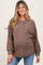 woman wearing a brown ribbed maternity top with buttons and long sleeves, showing her baby bump