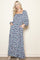 woman wearing a floral maxi dress with a square neckline and balloon sleeves, featuring pockets