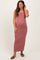 woman wearing a striped maternity maxi dress with buttons, showing her baby bump