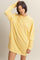 woman wearing a yellow oversized long sleeve sweatshirt dress