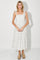 woman wearing a white floral midi dress with bow tie straps and a flowy silhouette