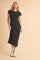woman wearing a black fitted midi dress and white cowboy boots
