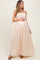 woman wearing a beige lace bodice maternity maxi dress and holding her baby bump