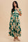 woman wearing a green floral maxi dress with short sleeves and a tiered skirt