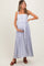 woman wearing a light blue floral maternity maxi dress and holding her baby bump