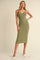 woman wearing a green ribbed midi dress with button details and a fitted silhouette