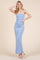 woman wearing a light blue spaghetti strap maxi dress with ruching details