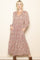 woman wearing a long sleeve floral maxi dress with a v-neck and pockets, styled with brown ankle boots