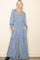 woman wearing a blue floral long sleeve maxi dress with a square neckline and pockets