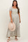 woman wearing a floral maternity maxi dress with puff sleeves and a matching hat, showcasing her baby bump