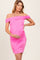 woman wearing a bright pink off-the-shoulder maternity dress with ruched detailing and displaying her baby bump