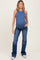 woman wearing a navy blue sleeveless maternity tank top and flared jeans, showing her baby bump