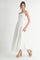 woman wearing a white maxi dress with a smocked bodice and eyelet detailing, paired with brown platform heels