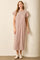 woman wearing a pink and white striped maxi dress with short sleeves and a relaxed fit