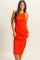 woman wearing a fitted bright orange ribbed midi dress with a halter neck design