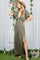 woman wearing an olive green maxi dress with a deep v-neck and side slit, holding a straw hat