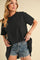 woman wearing a black oversized t-shirt and distressed denim shorts