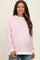 woman wearing a light pink striped maternity sweatshirt with white cuffs and a baby bump visible