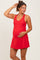 woman wearing a red sleeveless maternity dress and holding her baby bump