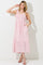 woman wearing a pink floral print maxi dress with smocked bodice and tie straps, featuring pockets and a tiered skirt