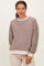 woman wearing a striped brown maternity sweatshirt with a relaxed fit and crew neckline