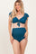 woman wearing a teal maternity bikini with ruffle sleeves and high-waisted bottom, showing her baby bump