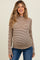 woman wearing a brown and beige striped long sleeve maternity top and showing her baby bump