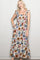 woman wearing a floral print maxi dress with ruffled straps and a tiered design