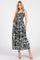 woman wearing a navy blue floral maxi dress with ruffled straps and pocket details
