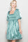 woman wearing a teal satin short dress with puff sleeves and a square neckline