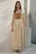 woman wearing a long striped tan and white maxi dress with buttons and a fitted top over a short sleeve white tee