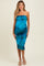 woman wearing a teal strapless maternity dress with a fitted silhouette and ruching at the sides, showing her baby bump
